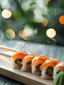 美食背景寿司摄影照片_用筷子在木材背景上寿司