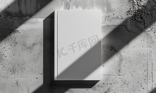 灰色商务模板摄影照片_中性灰色混凝土背景上带有柔和阴影的空白笔记本模型