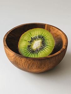 木碗里放着半个新鲜绿色猕猴桃