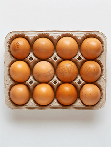 黄色背景框摄影照片_盒子里十个棕色鸡蛋的顶视图