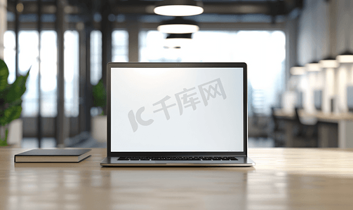 办公桌上带空白屏幕的笔记本电脑办公室内部背景模糊