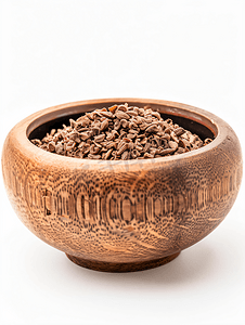 中药纹理摄影照片_白色背景棕色碗中的干印度楝或印度楝种子