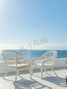 简约风家具海报摄影照片_阳光明媚的日子阳台上有两把白色藤椅