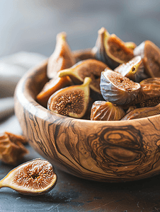 欧洲食品摄影照片_橄榄木碗中的甜无花果干