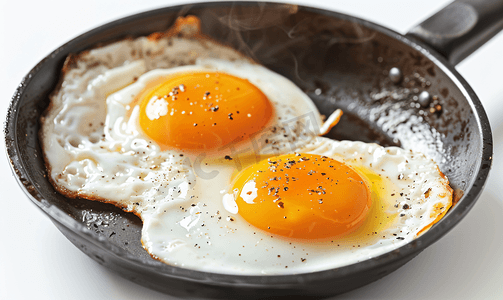 焙烧摄影照片_煎锅中煎两个鸡蛋