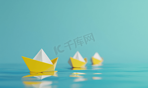 商业说明摄影照片_一艘白纸船引领着蓝色背景的三艘黄船