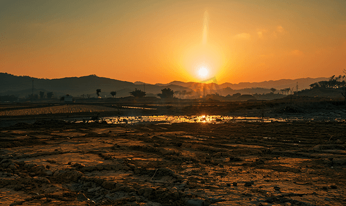 干旱摄影照片_傍晚夕阳下的干旱土地