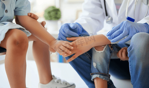 家庭医生在诊所检查儿童腿部的红皮疹