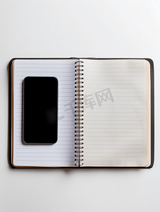笔记本空白页摄影照片_商业概念中左侧带有手机的空白页线规划书