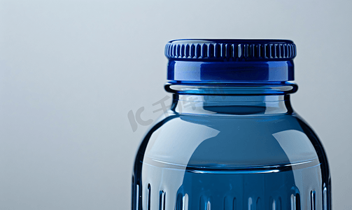 关闭可重复使用的水瓶与蓝色瓶盖孤立在白色