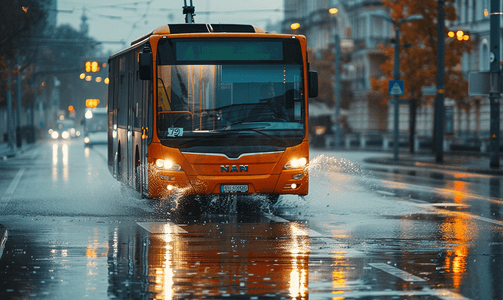 雨水花摄影照片_橙色市政巴士在雨路上行驶溅起水花