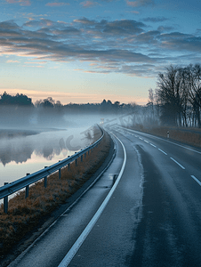 绿色河流风景摄影照片_夏季高速公路附近河流上有护栏清晨雾气弥漫