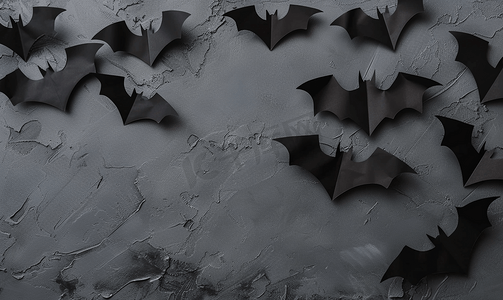 灰色背景上的万圣节概念黑纸蝙蝠复制空间