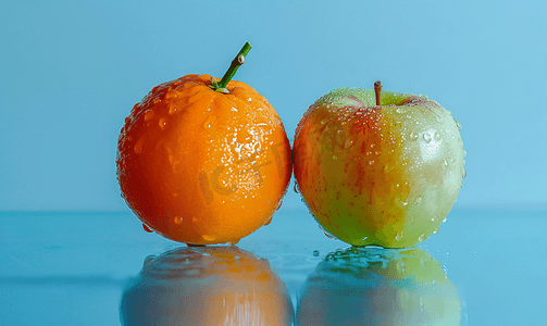 水果苹果橘子摄影照片_苹果和橘子放在蔬菜底座上