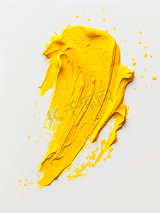 液体丙烯酸摄影照片_白色背景的黄色油漆