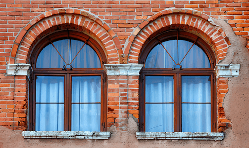 红砖墙上设有两扇拱形玻璃窗