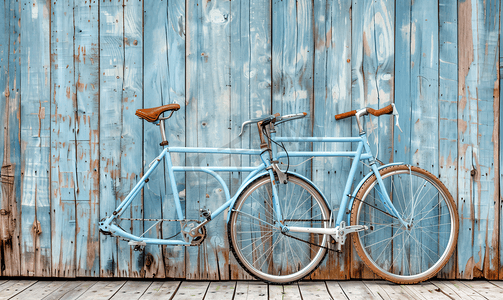 自行车复古摄影照片_自行车的一部分复古风格自行车的特写靠在粗糙的木墙上