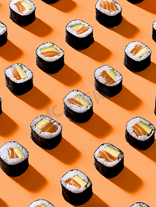 美食背景寿司摄影照片_亮橙色背景中的经典黑色寿司卷
