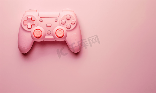 玩具机摄影照片_粉红色背景上的游戏控制器游戏手柄带有控制和控制游戏的设备
