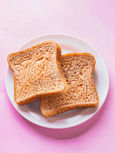 粉红色背景平躺板上的全麦三明治面包