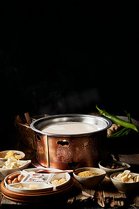 奶茶新品展架摄影照片_传统铜锅餐具装的蒙族炒米炖奶茶