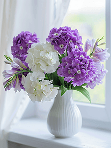 美丽花瓶摄影照片_美丽柔软的花瓶中盛开着紫色和白色的花朵