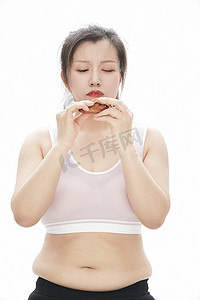 女性健康管理摄影照片_因暴饮暴食导致身材走样的亚洲女士