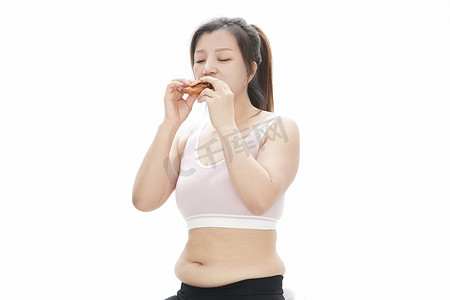 女性健康管理摄影照片_因暴饮暴食导致身材走样的亚洲女士