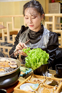 在韩式烤肉店享受美食的亚洲美女
