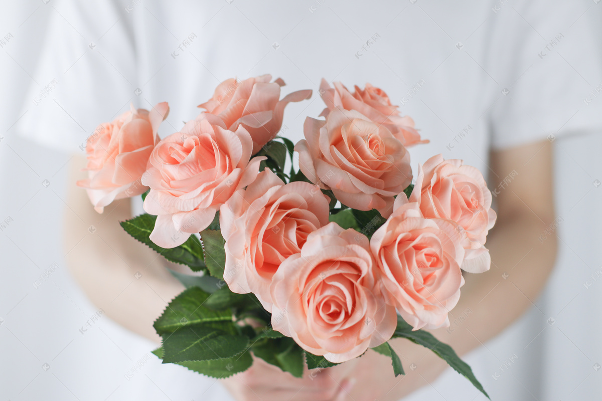 美丽的年轻女子捧着红玫瑰花束和拥抱她的男朋友图片-商业图片-正版原创图片下载购买-VEER图片库