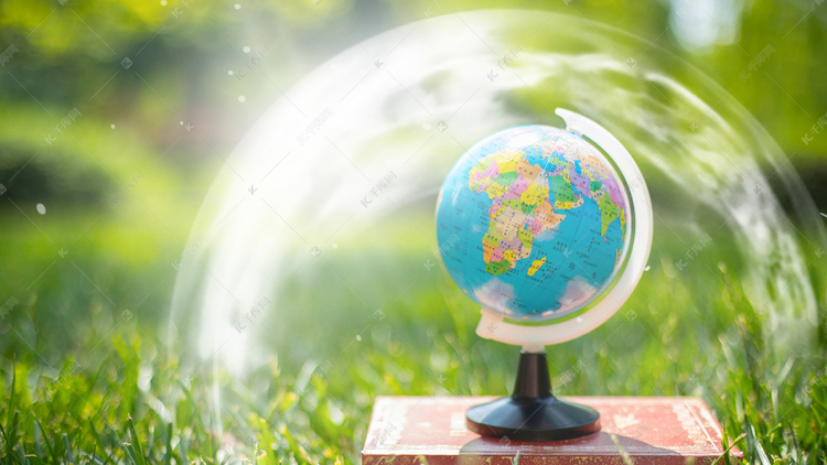 保护地球防护罩白天地球绿草地草地发光摄影图配图