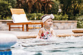 夏天儿童白天小女孩泳池边玩水摄影图配图
