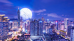 城市高楼明月当空夜晚城市月亮中秋节赏月摄影图配图