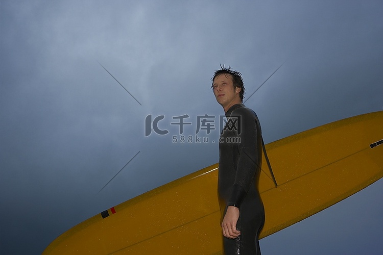 在海滩上携带冲浪板的冲浪者，侧视，低角度观看高清摄影大图 千库网