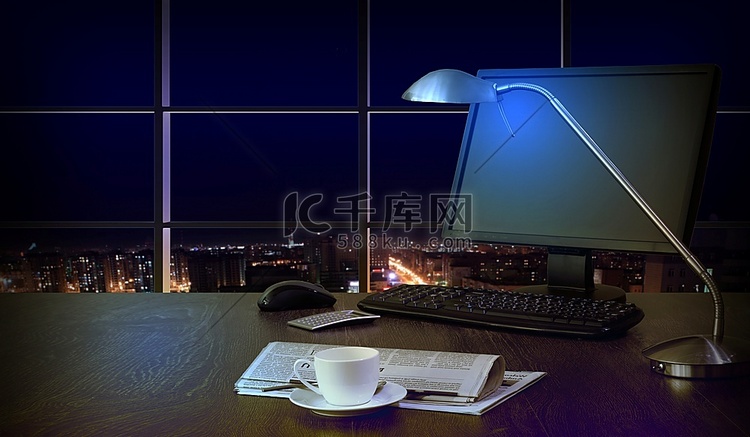 晚上在办公室工作,从窗户可以看到城市的景色高清摄影大图-千库网