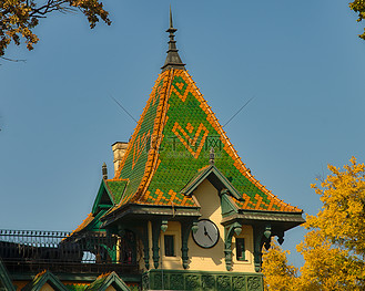 塔顶有时钟和绿色和橙色方形屋顶的建筑