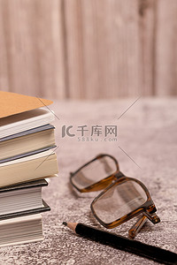 一副眼镜和一支黑色铅笔的一堆书高清摄影大图 千库网