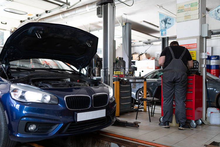 维修站一辆蓝色客车的照片，正在修理中，敞篷和工作机械师高清摄影大图-千库网