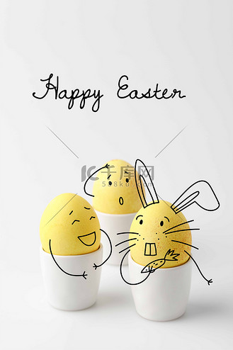 三黄色被绘的复活节蛋在蛋站立与滑稽画的面孔在白色
