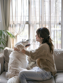 女人和狗坐在沙发上摄影配图