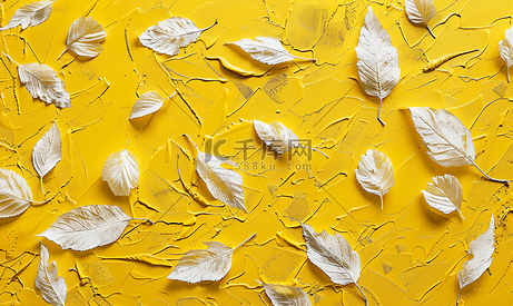 黄色背景纹理上的秋叶印记用黄色彩绘纸上的白色丙烯酸涂料制成