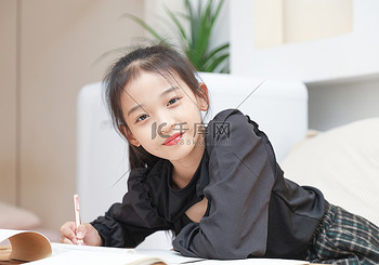 客厅沙发前写作业的小女孩