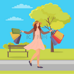 微笑的女人带着购物袋在春天走在
