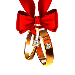 两个金结婚戒指绑着红丝带蝴蝶结