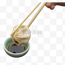 杂粮小笼包图片_筷子夹小笼包酱醋食物