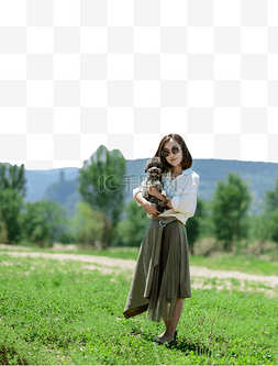 美女小狗绿草地上抱着