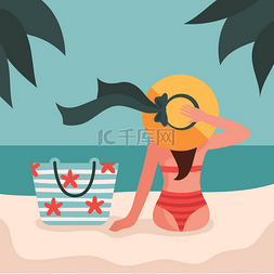 沙滩上的的女孩图片_一个穿着泳衣戴着帽子的女孩正坐