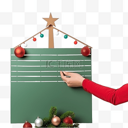贺卡封面图片_手把圣诞愿望清单放在圣诞树上