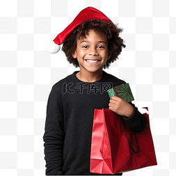 拎礼物图片_戴着圣诞帽的非洲裔美国男孩，在