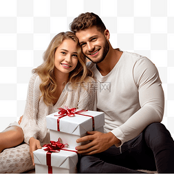 坐在一起的情侣图片_美丽的年轻夫妇坐在圣诞树旁，带